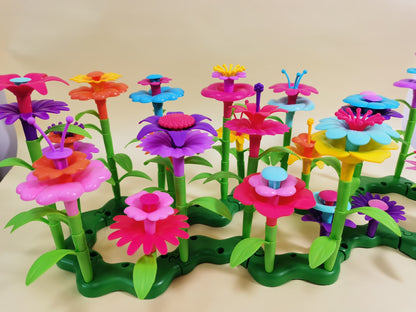 child’s hand assembling plastic garden blocks