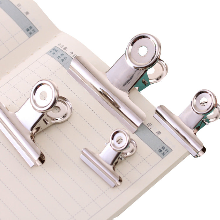 office paper clamps in silver round box