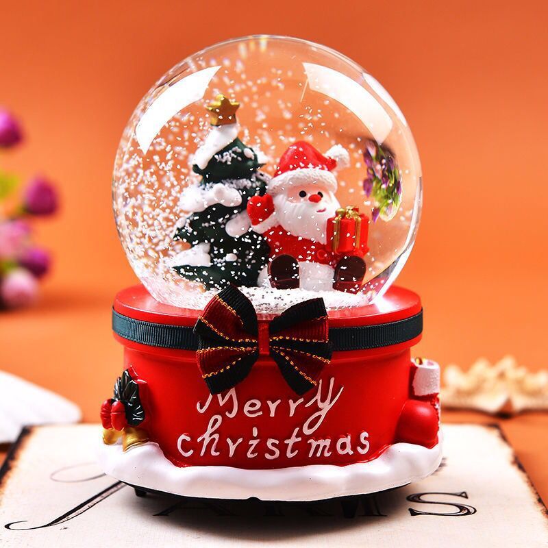 Festive snow globe with Santa and snowman figurines