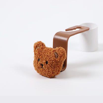 bear-shaped car seat hook in retail packaging